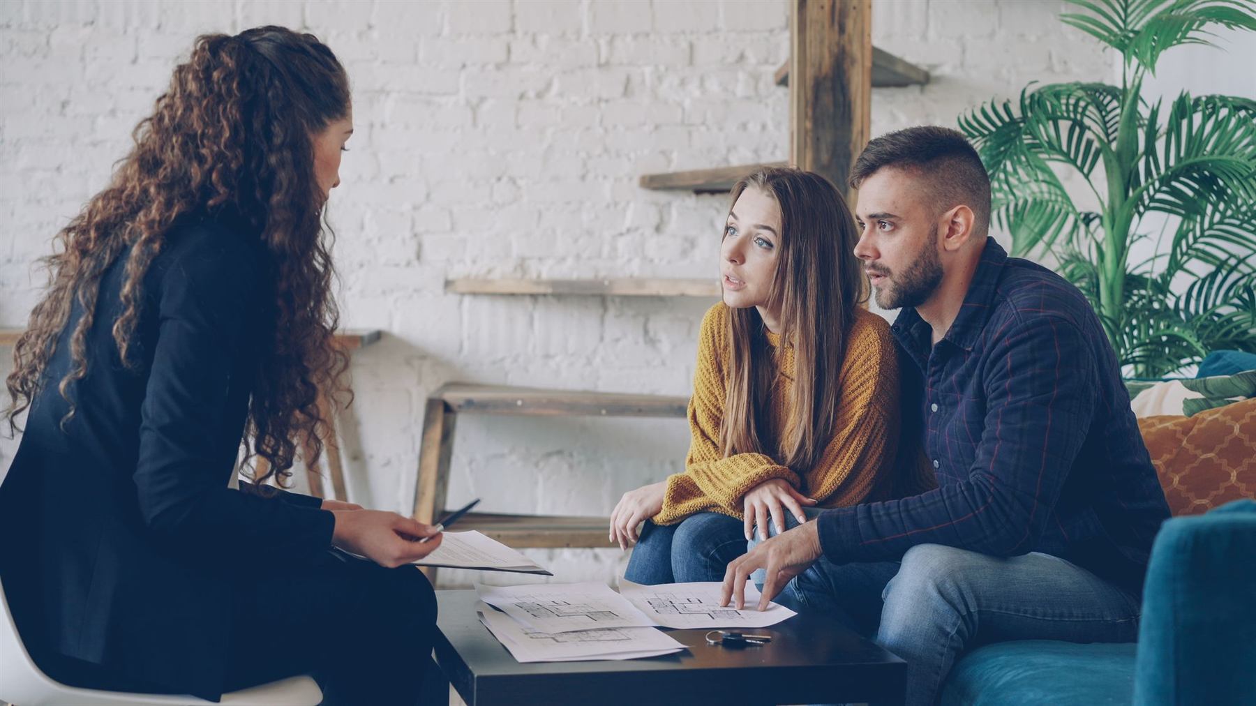 A bank advisor talking through documents with a young couple
