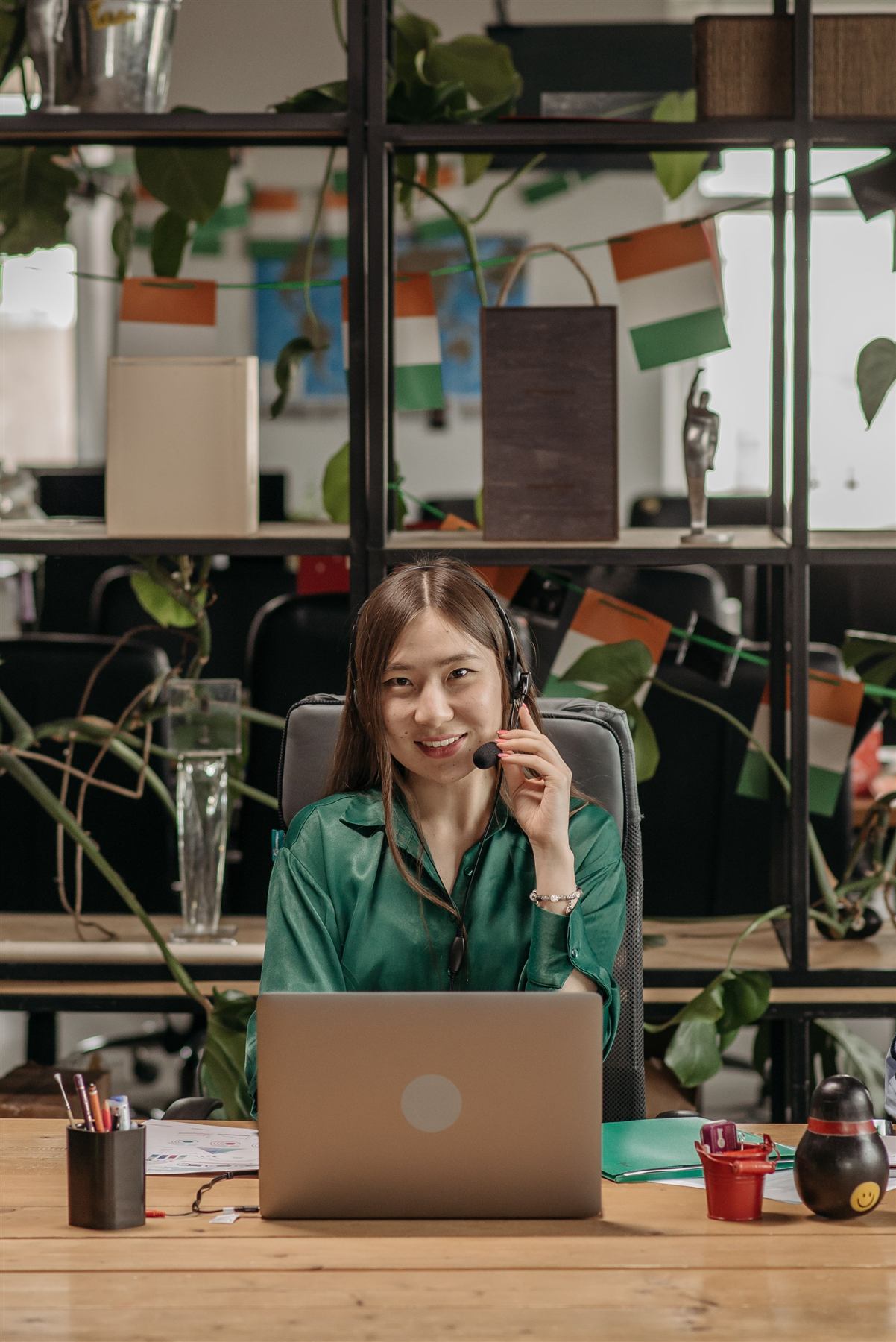 A smiling customer support agent wearing a headset